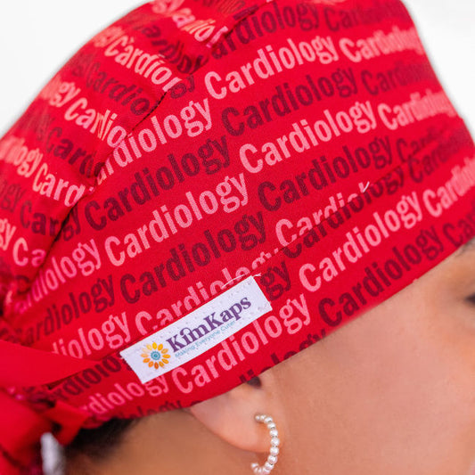 red ponytail scrub cap with the words Cardiology on it
