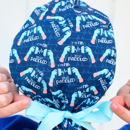 Ponytail style scrub cap with defibrillators