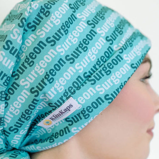 tieback surgical scrub cap in green with the word surgeon on it