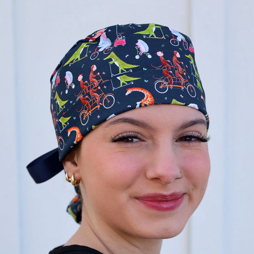 scrub cap with animals riding bikes and scooters